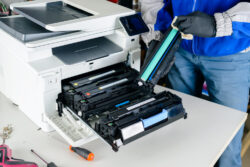 master professional refills laser printer cartridges in the workshop. specialist repairman serves or repairs the laser printer